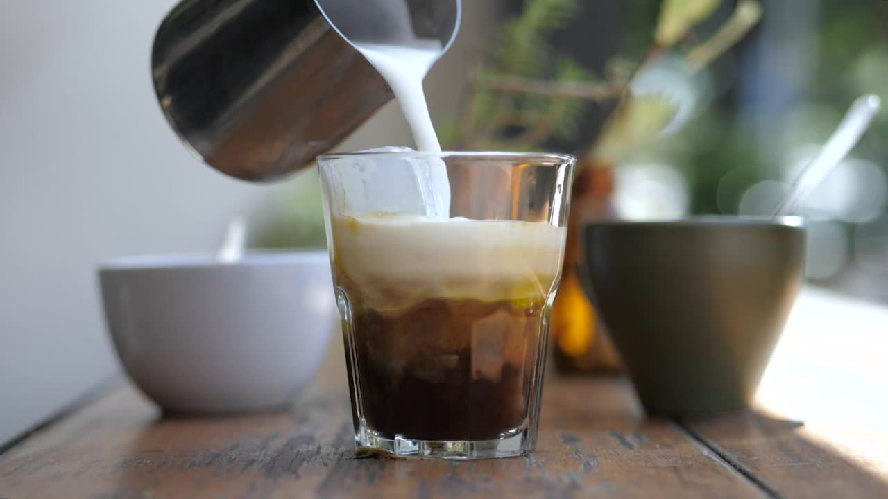 Stock Video A Barista Preparing Coffee With Milk And Ice Live Wallpaper for PC