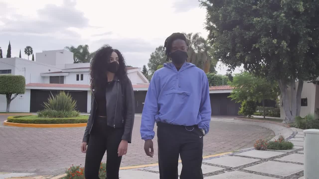 Stock Video A Boy And A Girl With Face Masks Walking Through Live Wallpaper for PC