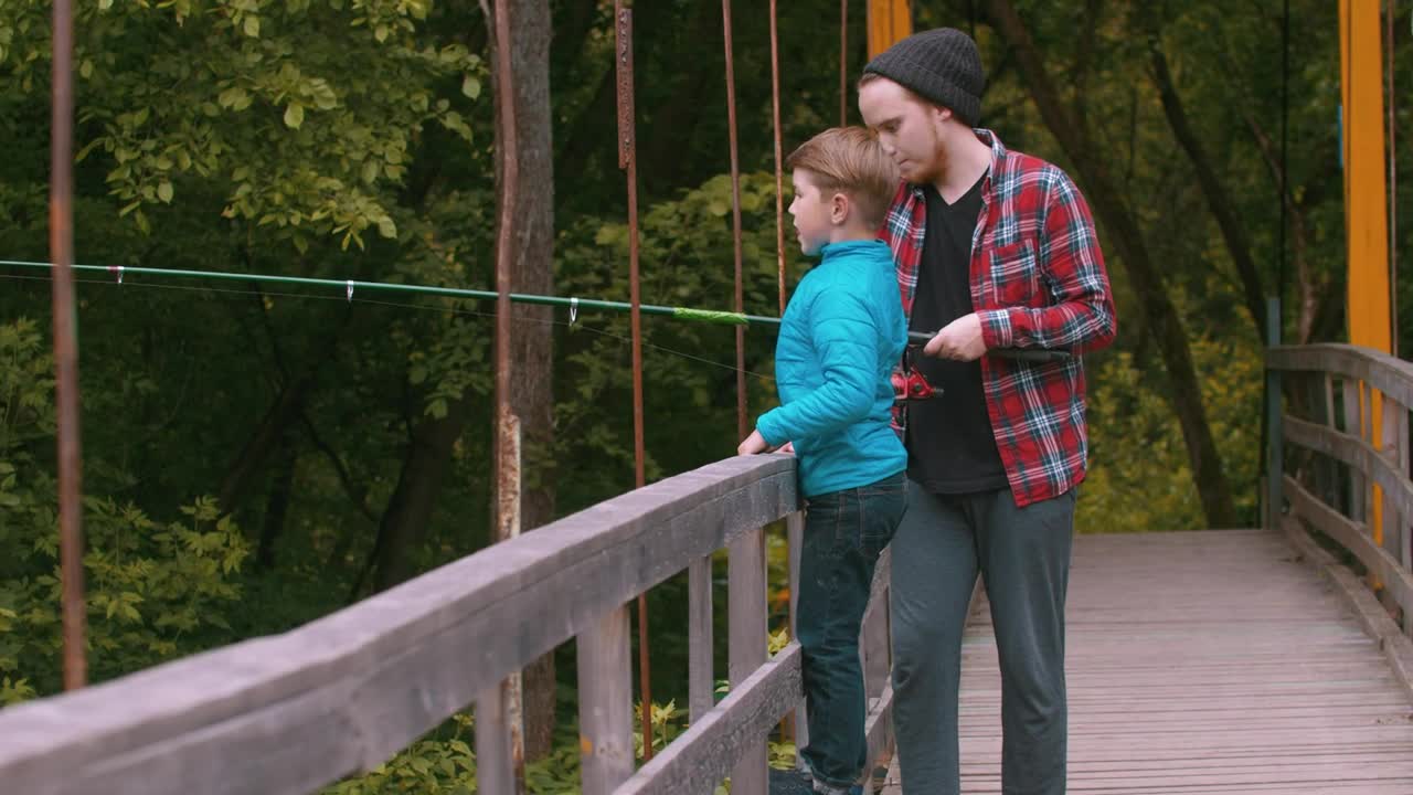Stock Video A Boy And A Man Fishing On A Bridge In Live Wallpaper for PC