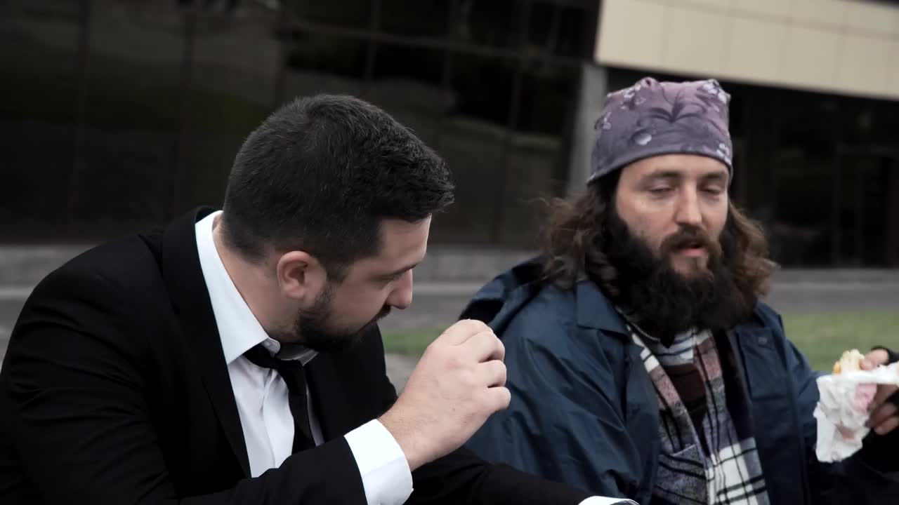 Stock Video A Business Man And Homeless Eating Together Live Wallpaper for PC