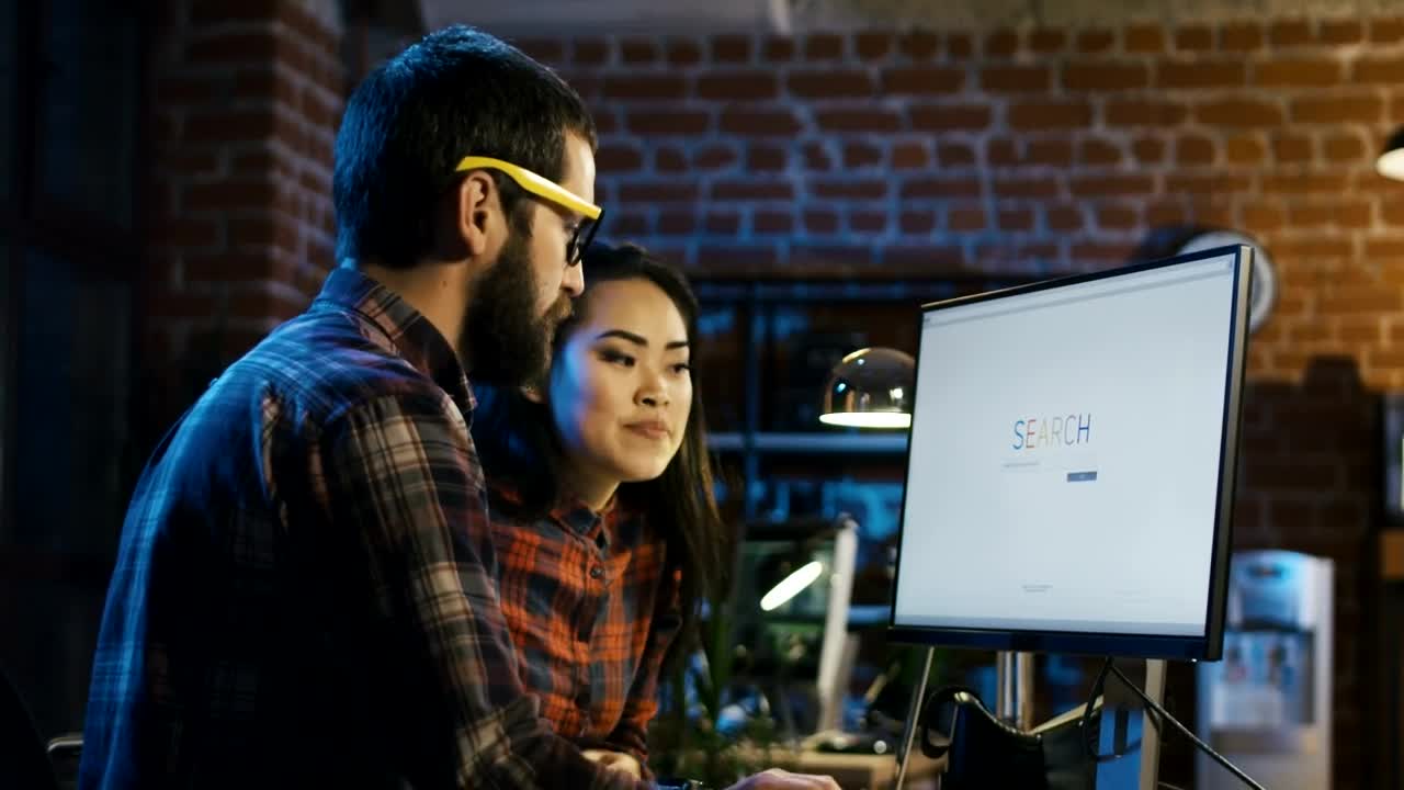 Stock Video A Couple Of Young Creatives Surfing The Internet Live Wallpaper for PC