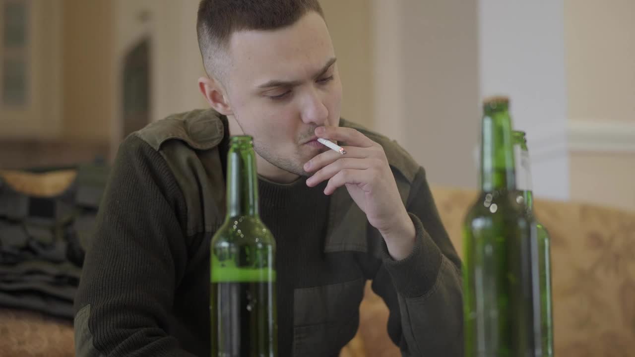 Stock Video Addict Sits On Sofa Smoking And Drinking Live Wallpaper for PC