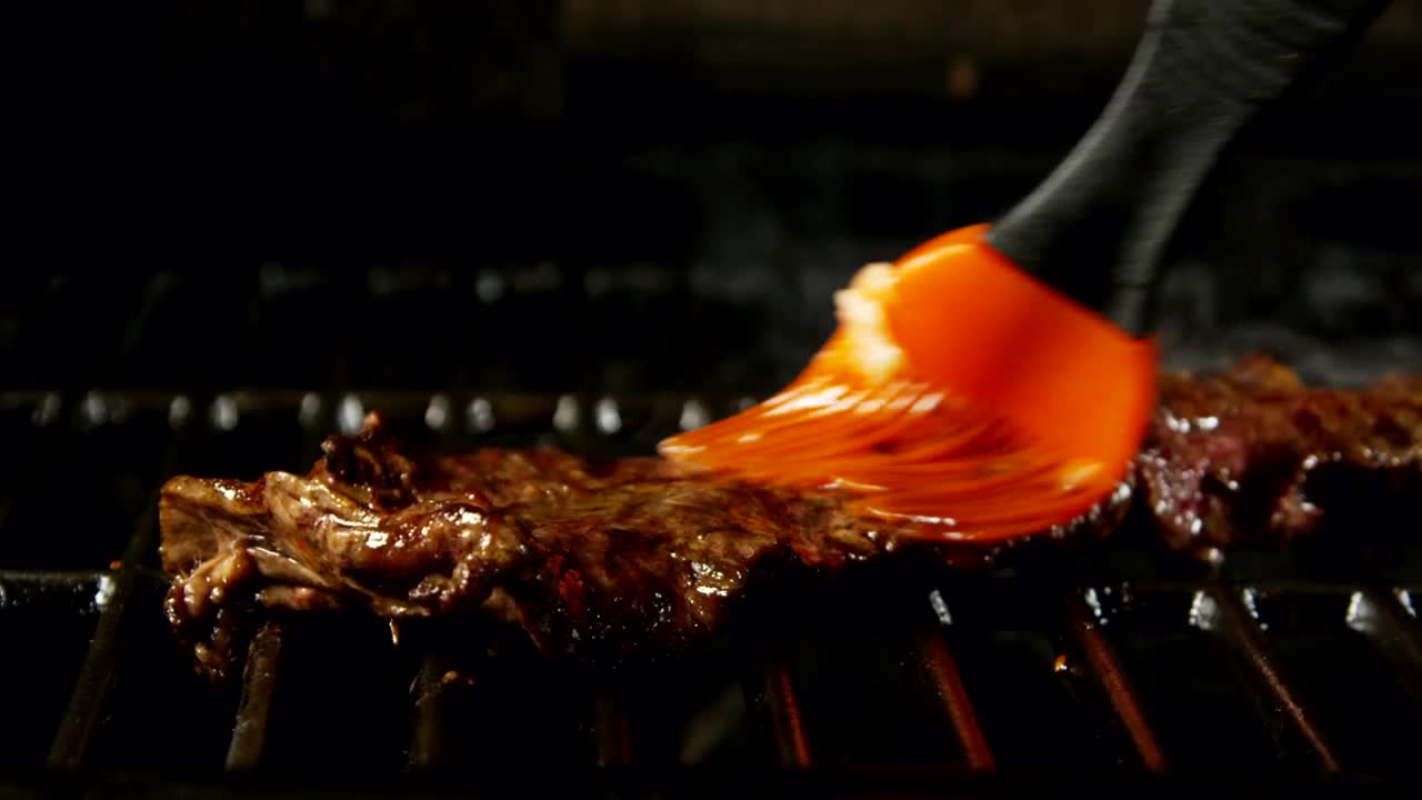 Stock Video Adding Sauce To A Steak On The Grill Live Wallpaper for PC