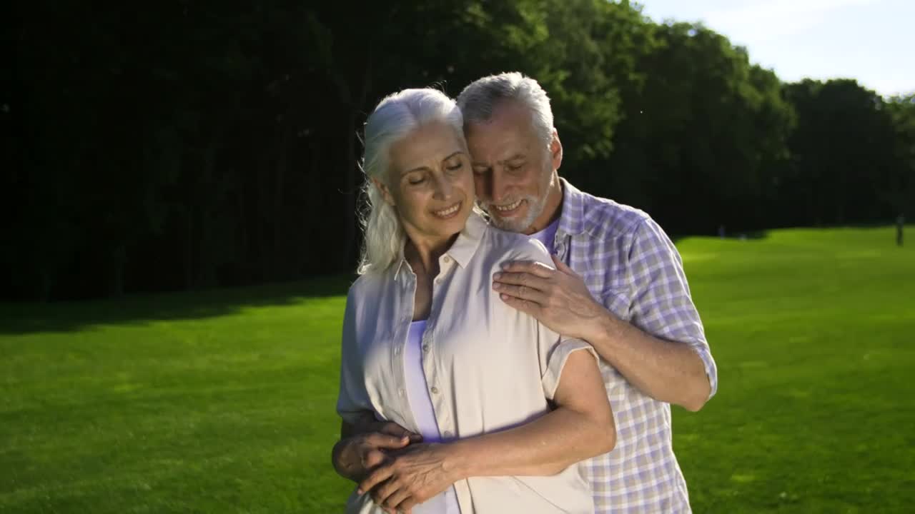 Stock Video Adult Man And Woman Embracing On A Meadow Live Wallpaper for PC