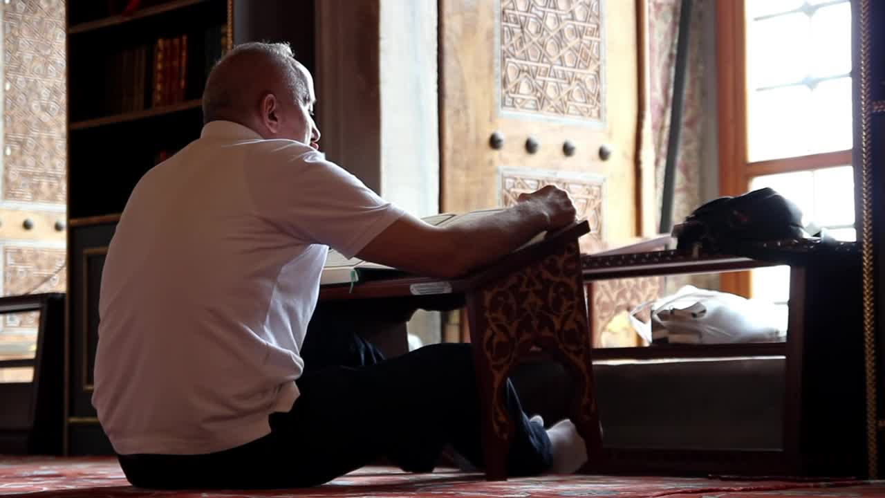 Stock Video Adult Man Reading The Quran Inside A Mosque Live Wallpaper for PC