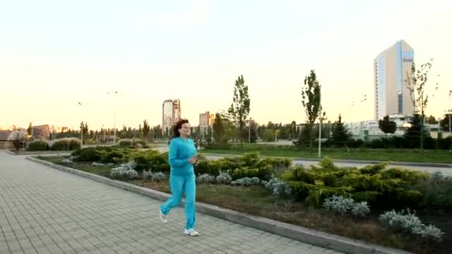 Stock Video Adult Woman Jogging Through A Large Garden Live Wallpaper for PC