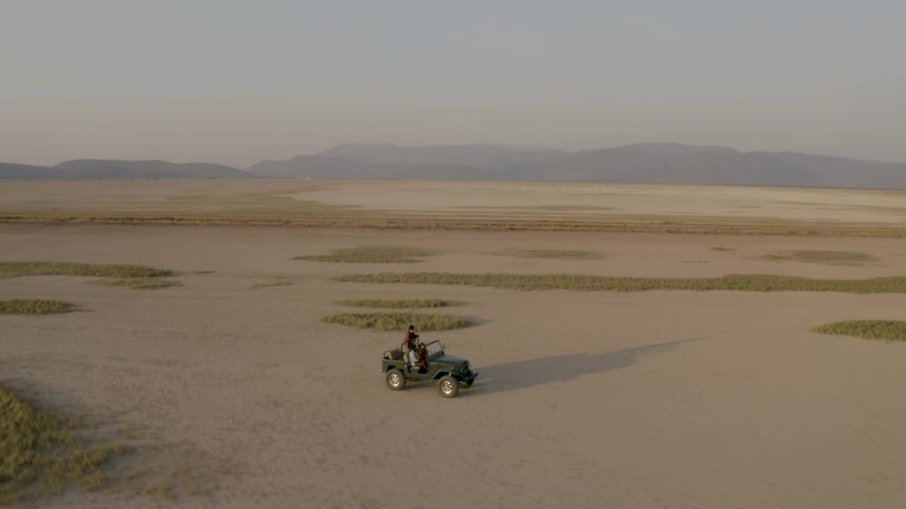 Stock Video Aerial Shot Of A Jeep Truck Traveling Through A Desert Live Wallpaper for PC