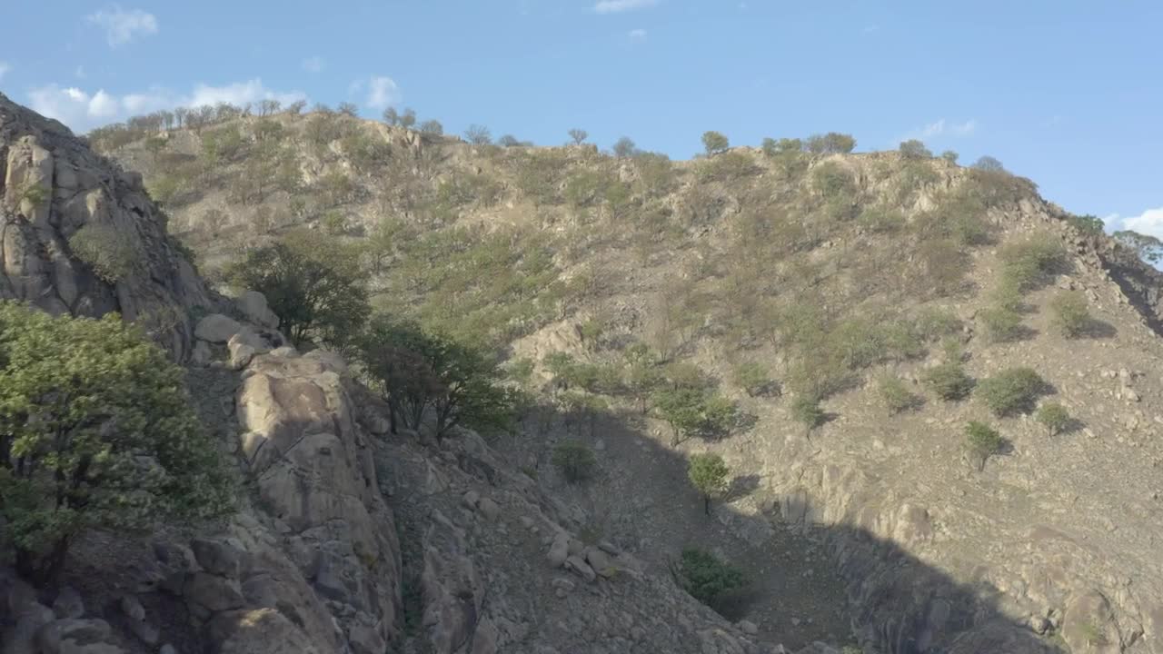 Stock Video Aerial Tour Between The Arid Hills Of A Mountain Range Live Wallpaper for PC