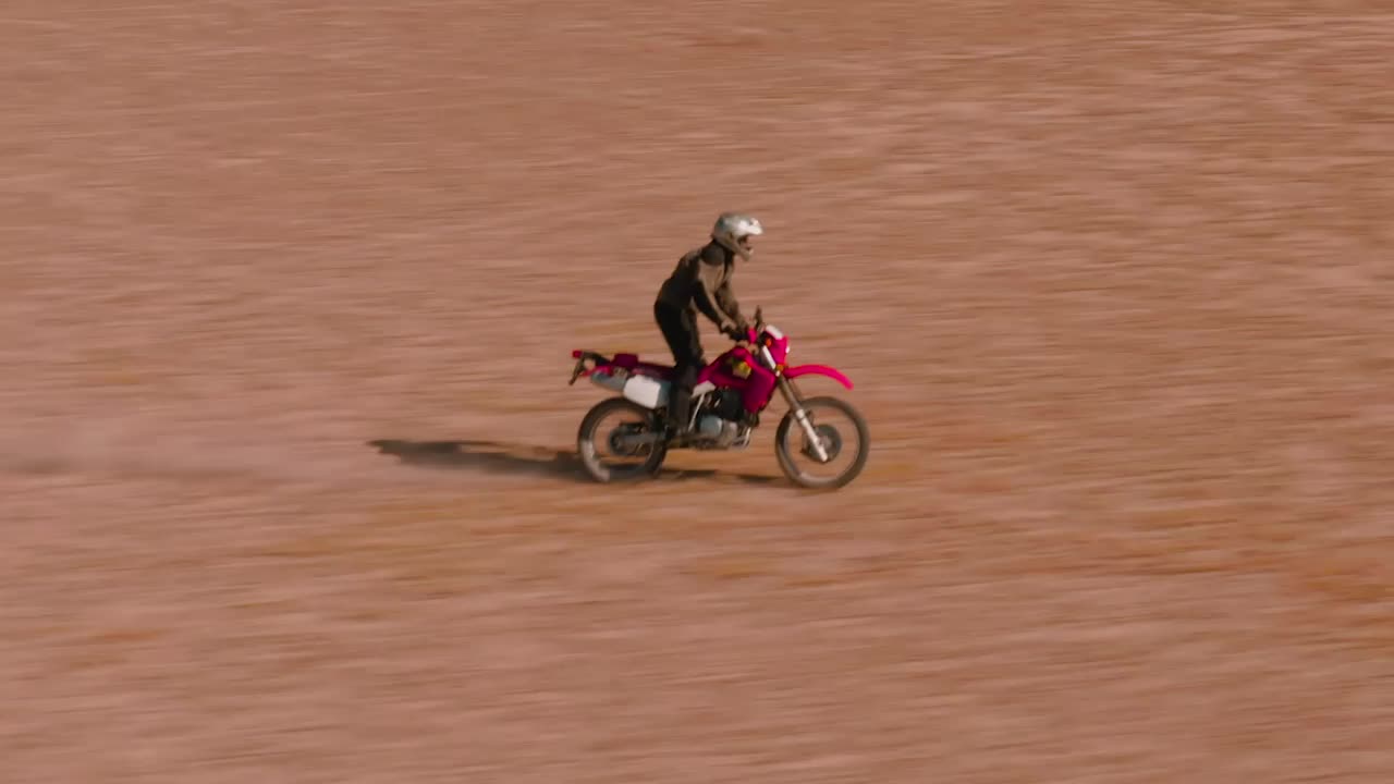 Stock Video Aerial Tracking Of A Man On A Motorcycle In The Live Wallpaper for PC