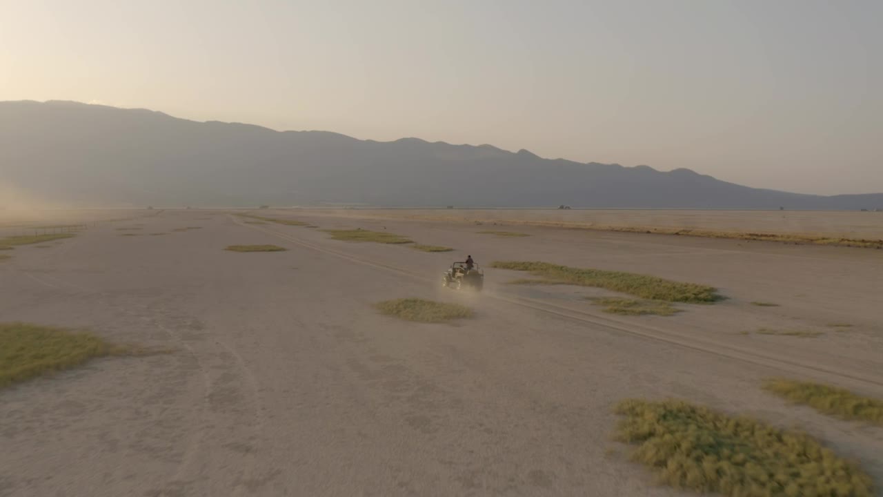 Stock Video Aerial View Of A Jeep Traveling Through A Desert At Live Wallpaper for PC