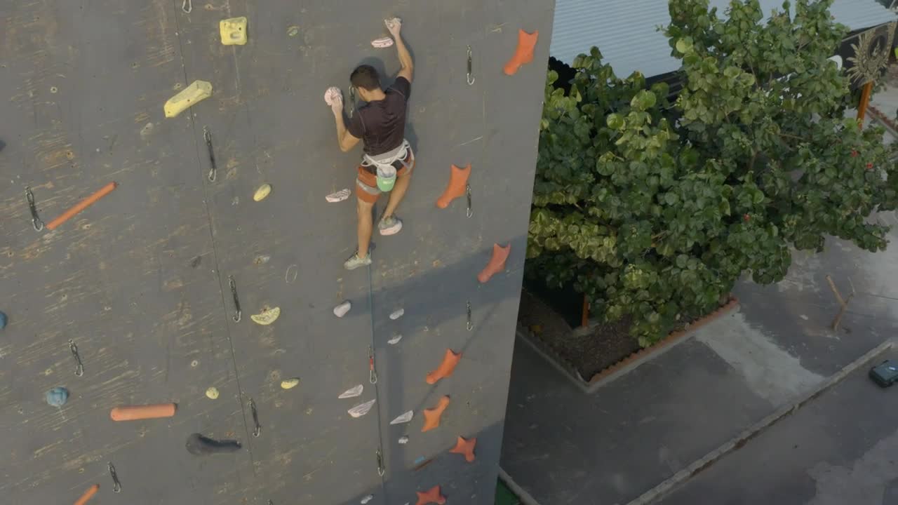 Stock Video Aerial View Of A Mountaineer On Top Of A Wall Live Wallpaper for PC