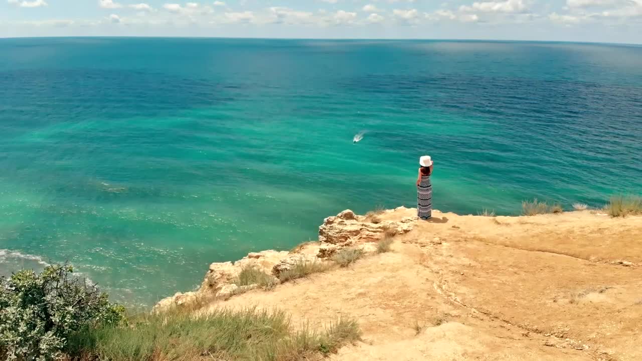 Stock Video Aerial View Of A Woman Looking Out To Sea From Live Wallpaper for PC