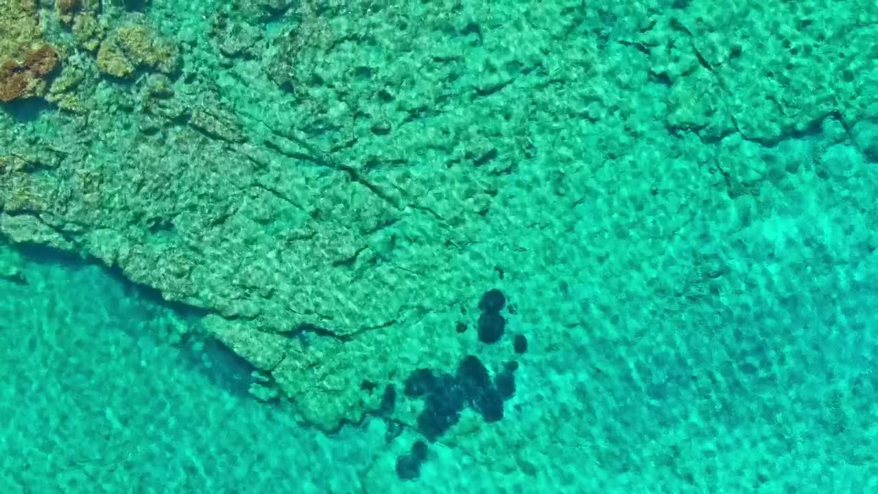Stock Video Aerial View Of Crystal Clear Rocky Sea Shore Live Wallpaper for PC