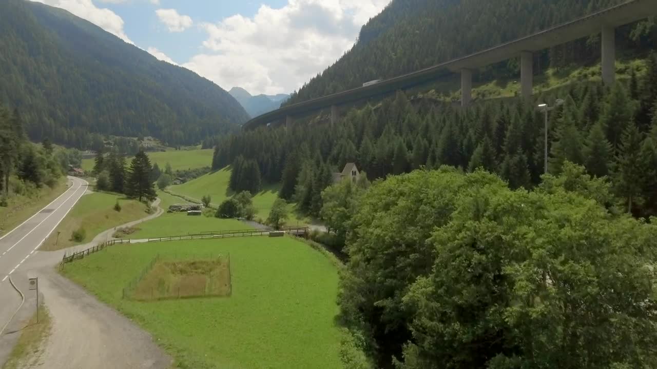 Stock Video Aerial View Of Highway Around Forested Mountain Live Wallpaper for PC