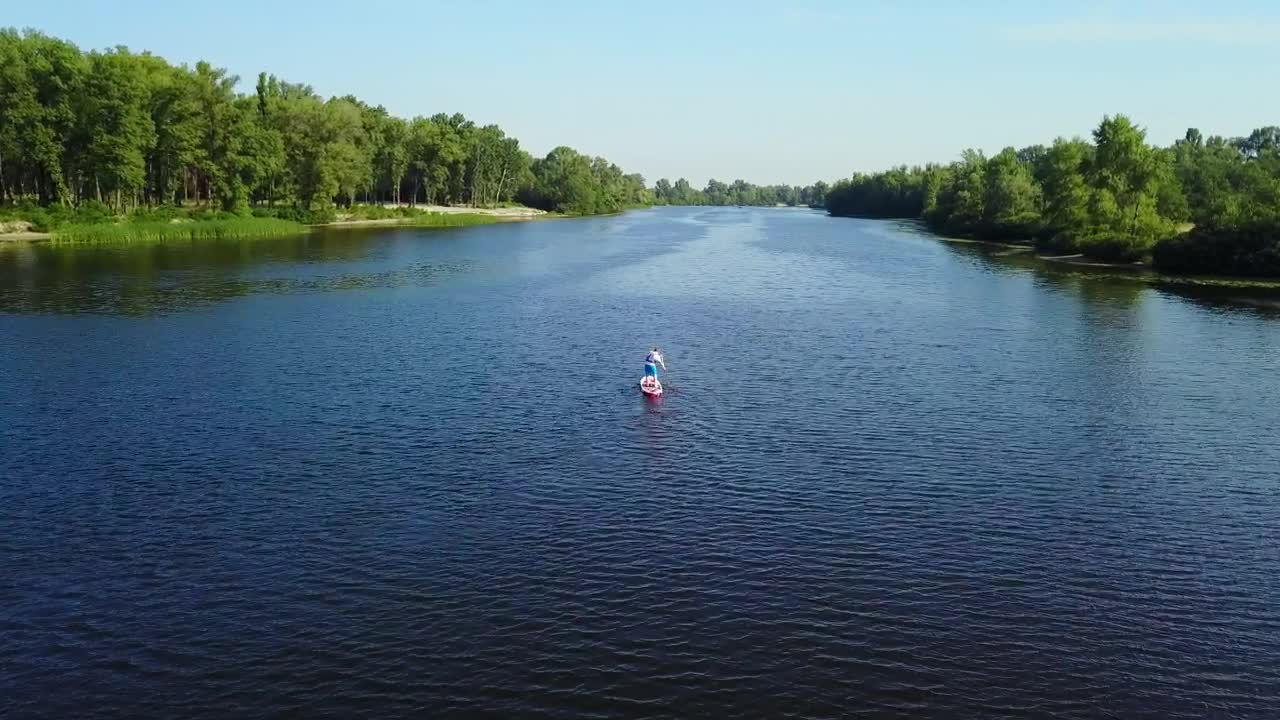 Stock Video Aerial View Of Man On Paddle Board In River Live Wallpaper for PC