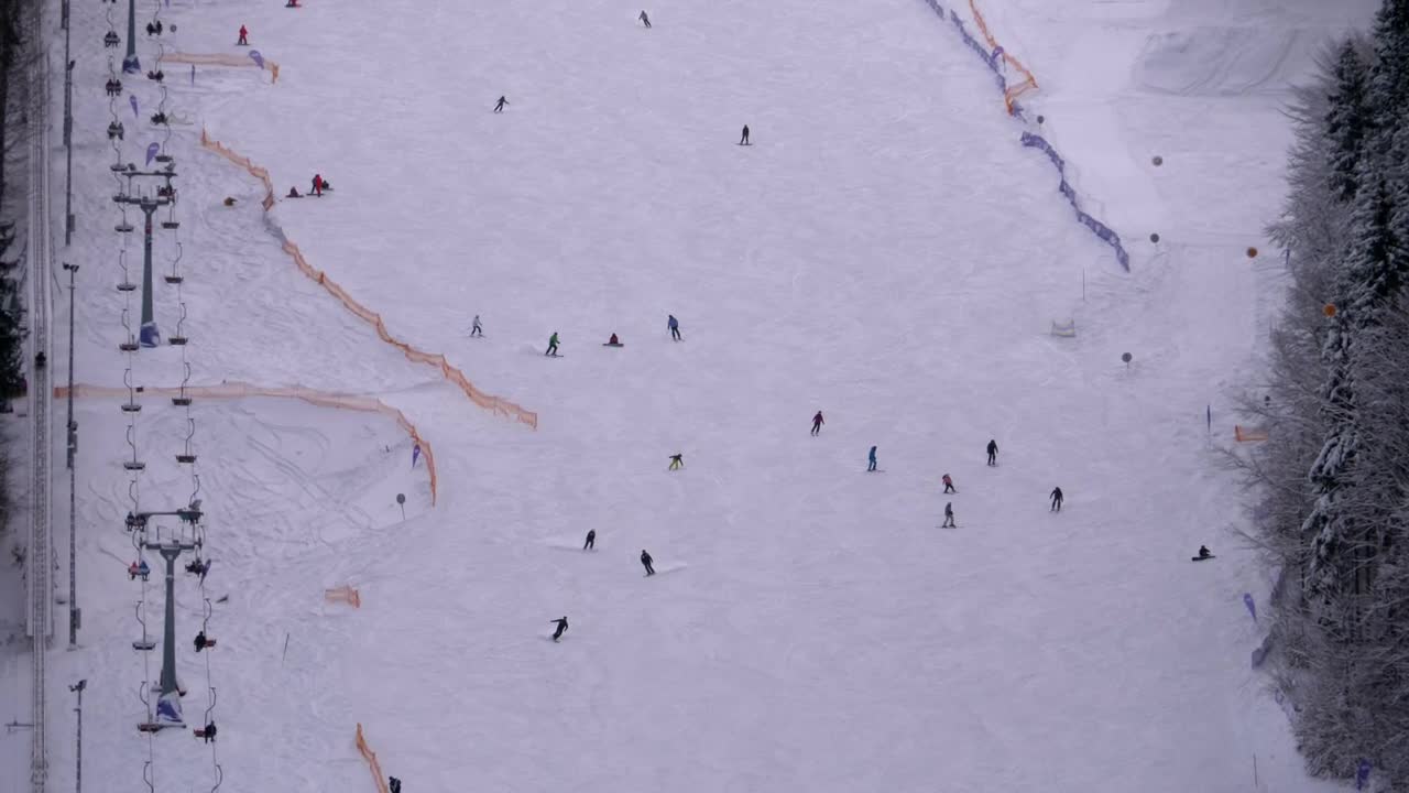 Stock Video Aerial View Of Skiers Going Down The Winter Mountain Live Wallpaper for PC