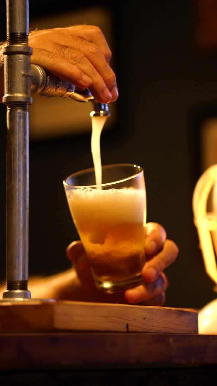Stock Video Bartender Serving Beer From A Tap Looking Down At His Live Wallpaper For PC