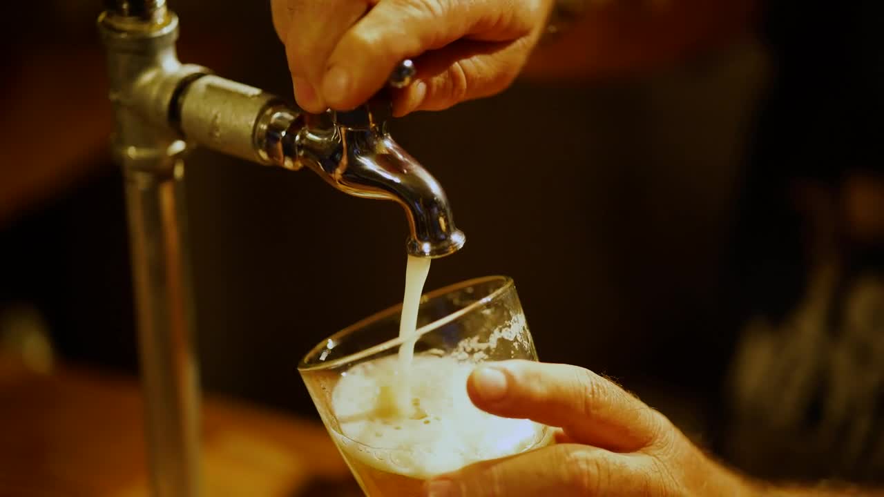 Stock Video Bartender Serving Beer From A Tap In A Glass In Live Wallpaper For PC