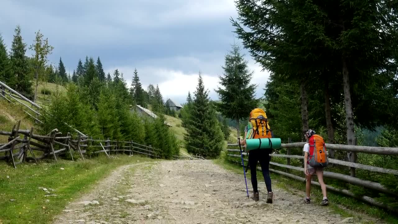 Stock Video Backpackers Walking Through A Rural Road Live Wallpaper For PC