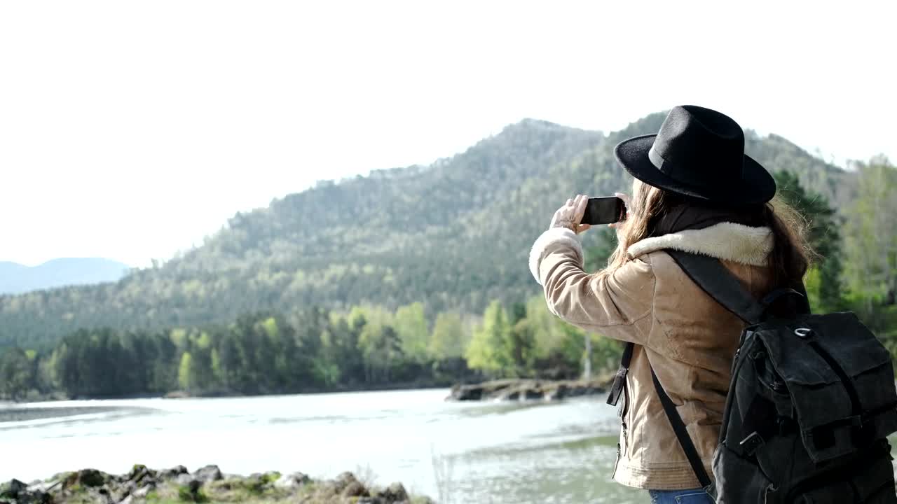 Stock Video Backpacker Takes Panoramic Photo Of River And Mountains Live Wallpaper For PC