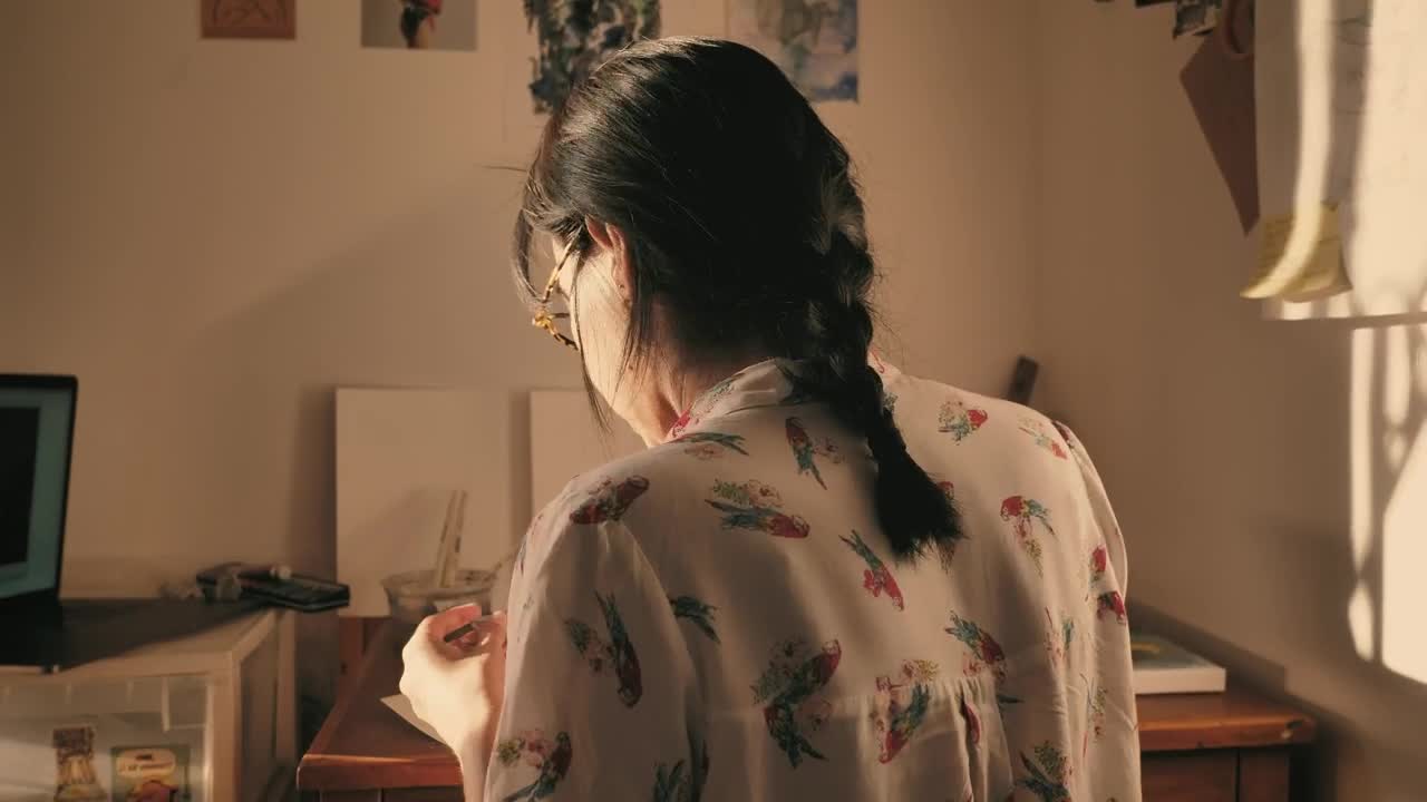 Stock Video Artist Seen From Behind Painting In Her Studio Live Wallpaper For PC