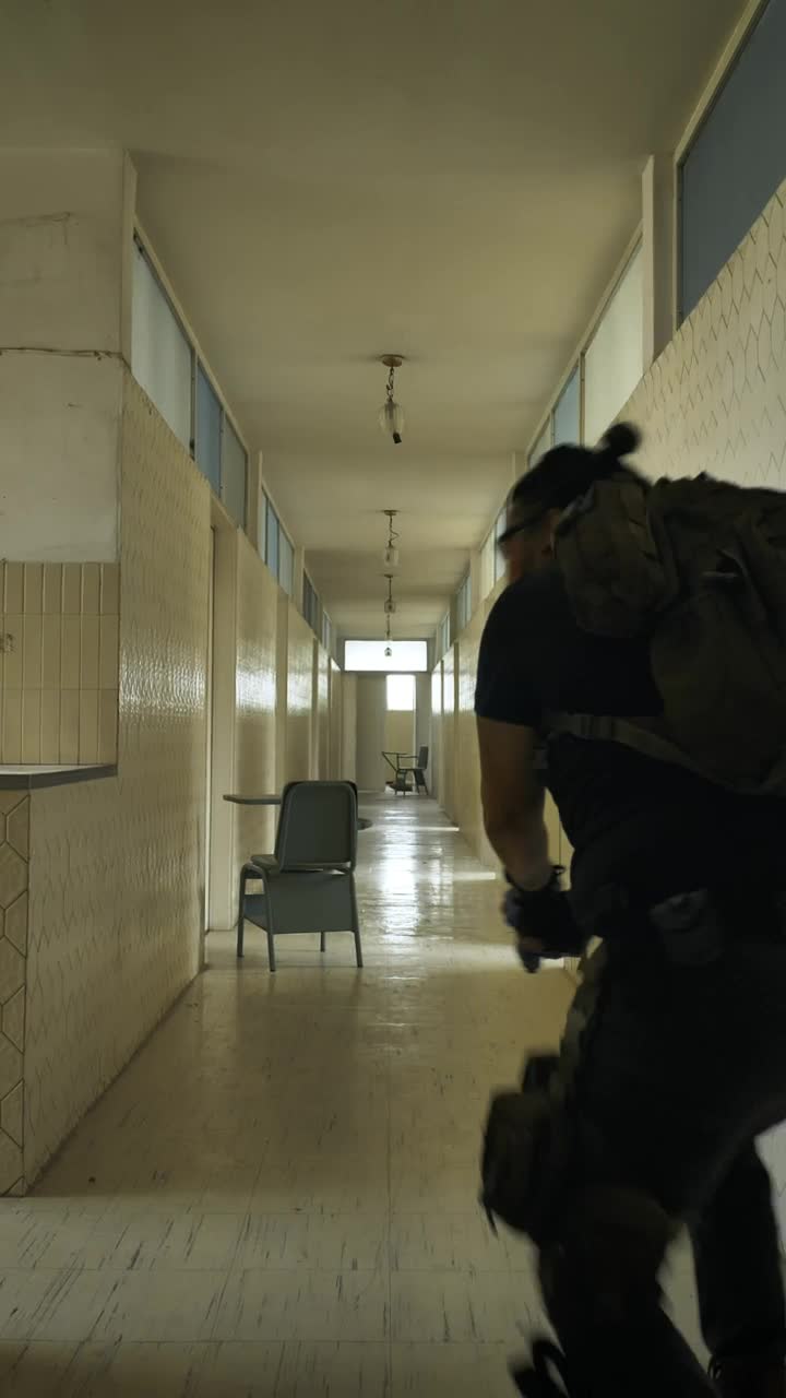 Stock Video Armed Man Securing An Area In An Empty Building Live Wallpaper For PC
