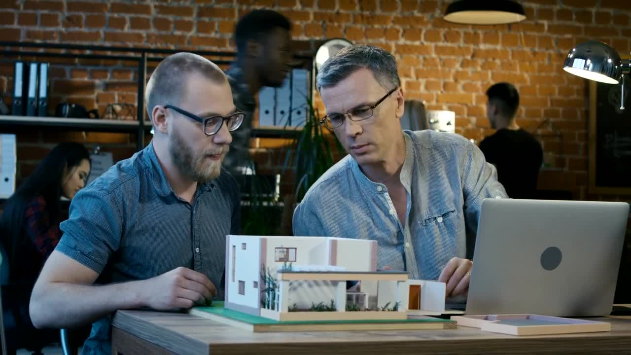 Stock Video Architects Checking A House Model At The Office Live Wallpaper For PC