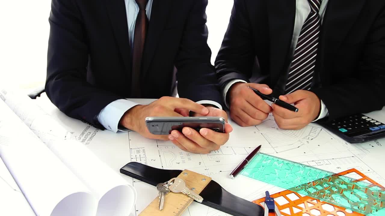 Stock Video Architect Showing Pictures Of A Property To A Man Live Wallpaper For PC