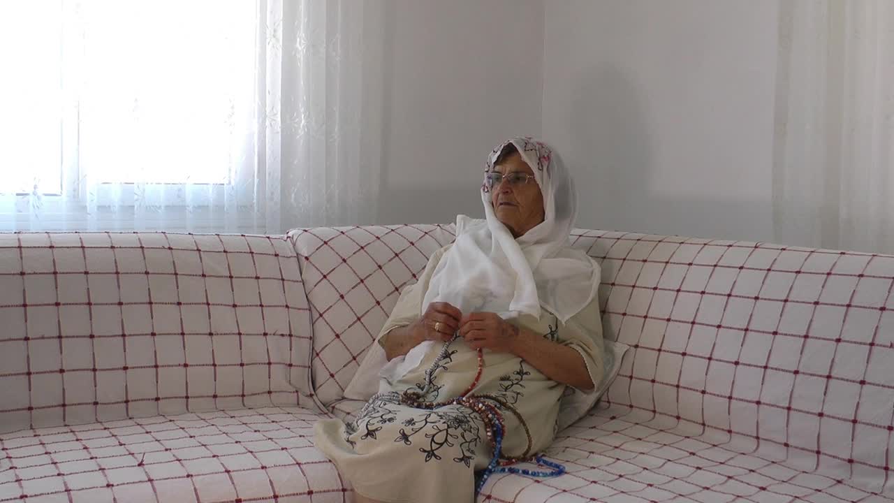 Stock Video Arab Old Woman Praying With A Rosary At Home Live Wallpaper For PC