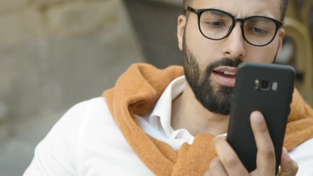 Stock Video Arab Man Smiles While Using Mobile App Live Wallpaper For PC