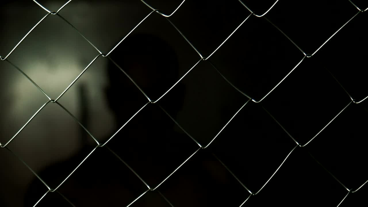 Stock Video Angry Prisoner Behind A Wire Fence Live Wallpaper For PC