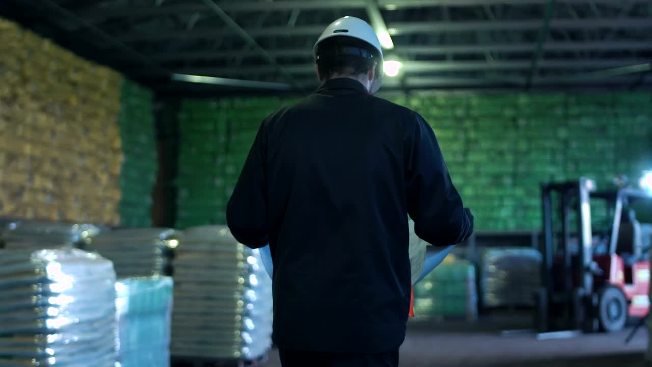 Stock Video An Engineer With Blueprint Walking On A Warehouse Live Wallpaper For PC
