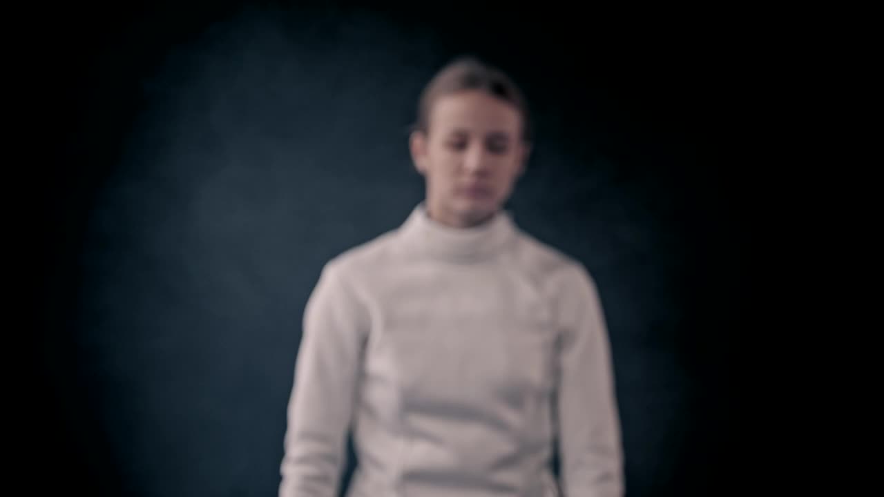 Stock Video A Young Woman Fencer Posing With Her Sword Live Wallpaper For PC