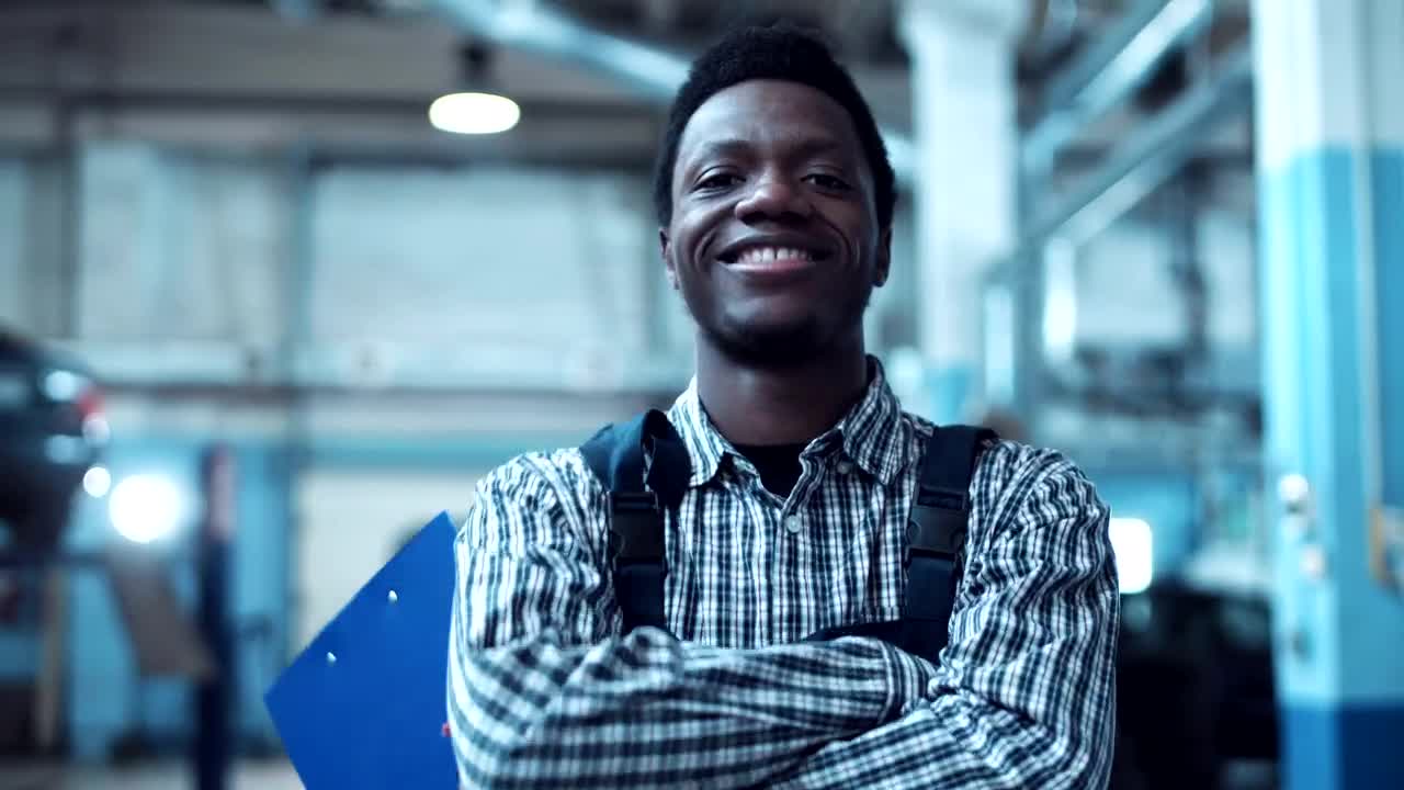 Stock Video A Young Mechanic Is Smiling To The Camera Live Wallpaper For PC