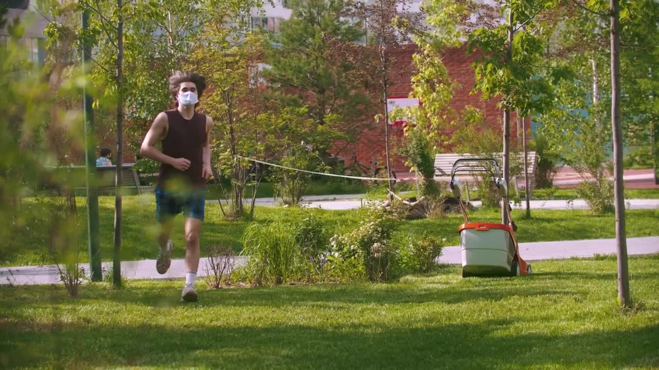 Stock Video A Young Man With A Medical Mask Exercising In The Live Wallpaper For PC