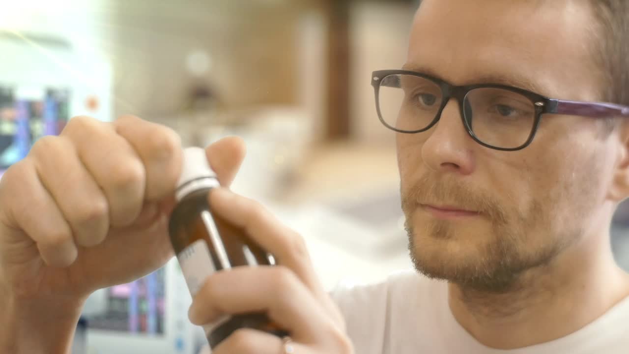 Stock Video A Young Man With Glasses Taking Medicine In The Hospital Live Wallpaper For PC