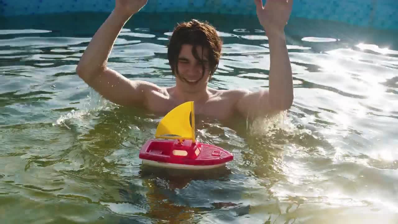 Stock Video A Young Man In The Pool With A Toy Boat Live Wallpaper For PC