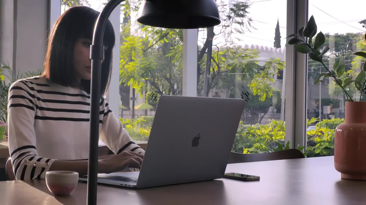 Stock Video A Woman Working On Her Laptop At An Office Live Wallpaper For PC