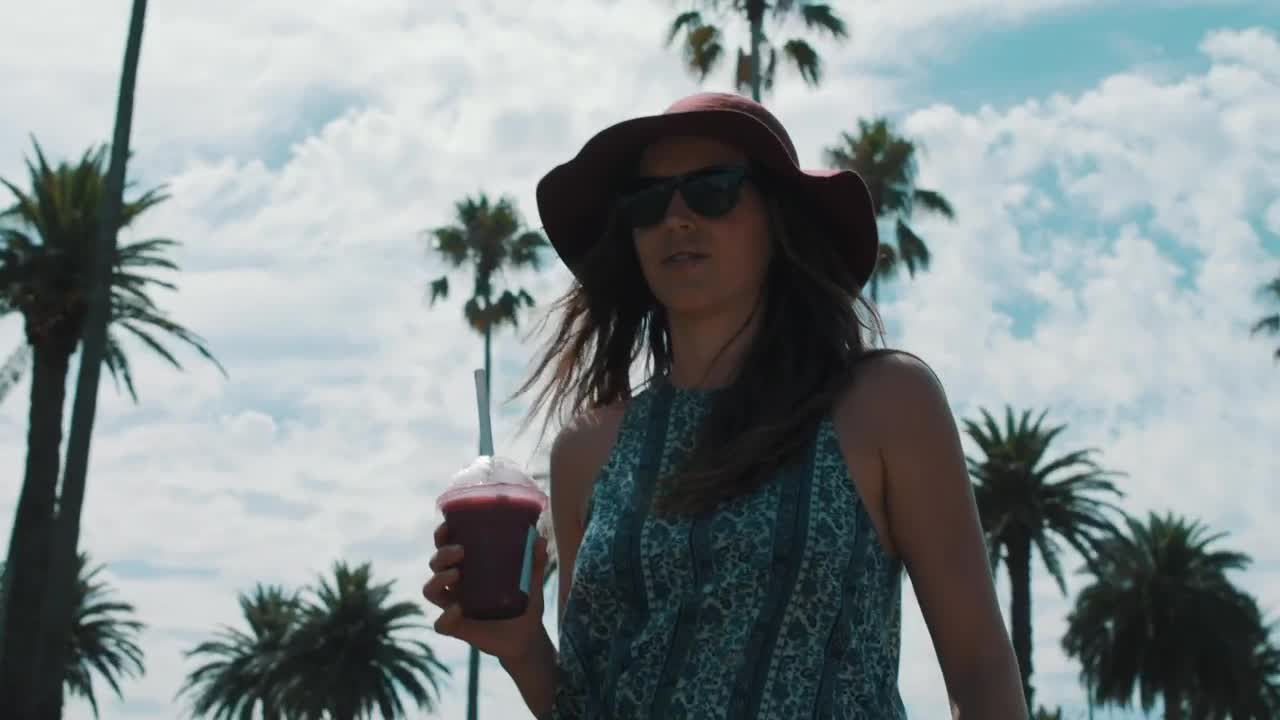 Stock Video A Woman Walking And Drinking A Smoothie Live Wallpaper For PC