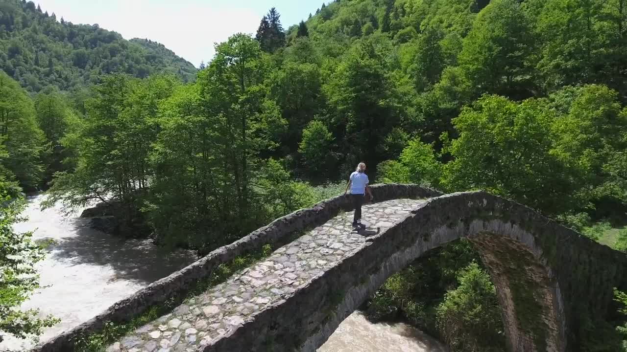 Stock Video A Woman Standing On A Bridge Over A Stream Live Wallpaper For PC