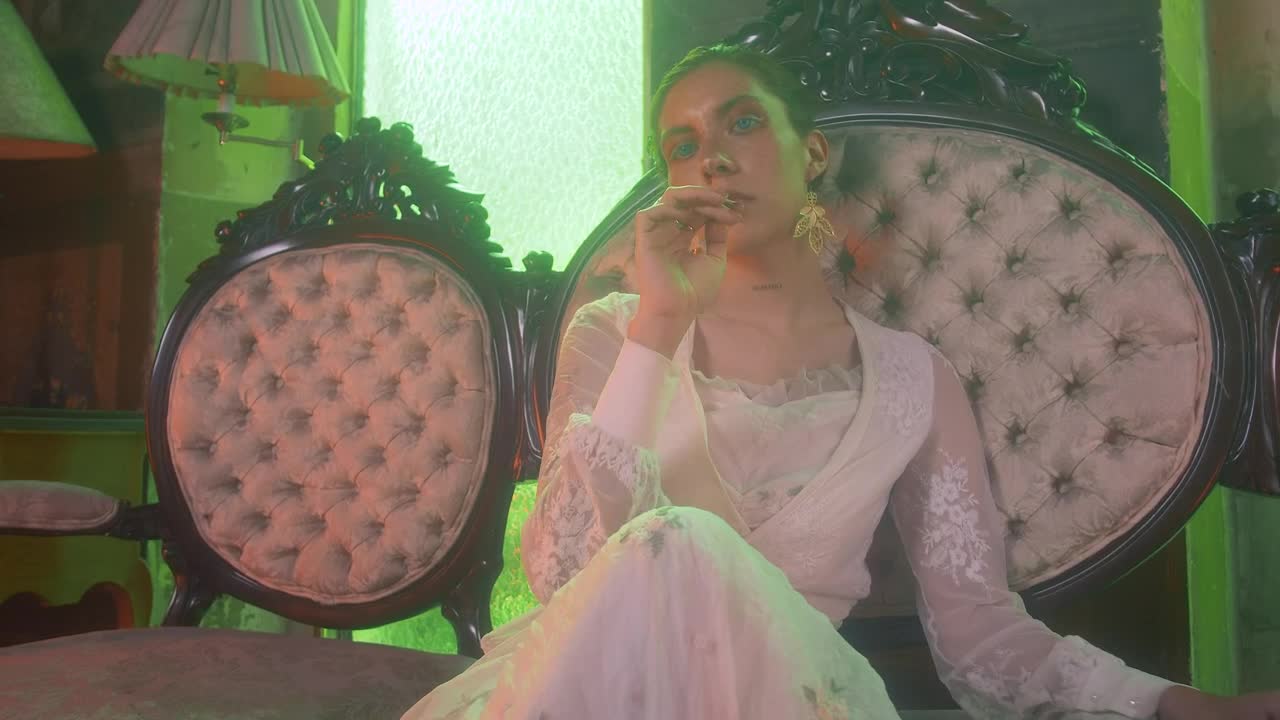 Stock Video A Woman Sitting In A Vintage Couch Looks Into The Live Wallpaper For PC