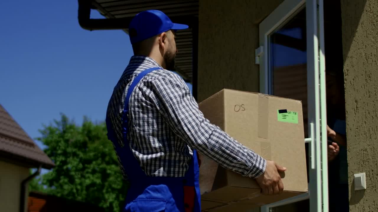 Stock Video A Woman Receives A Package From The Delivery Guy Live Wallpaper For PC