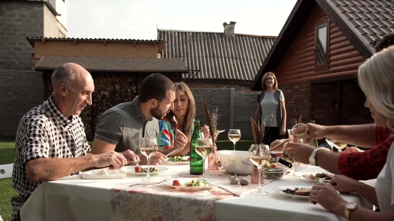 Stock Video A Woman Arrives To Family Dinner In The Backyard Live Wallpaper For PC