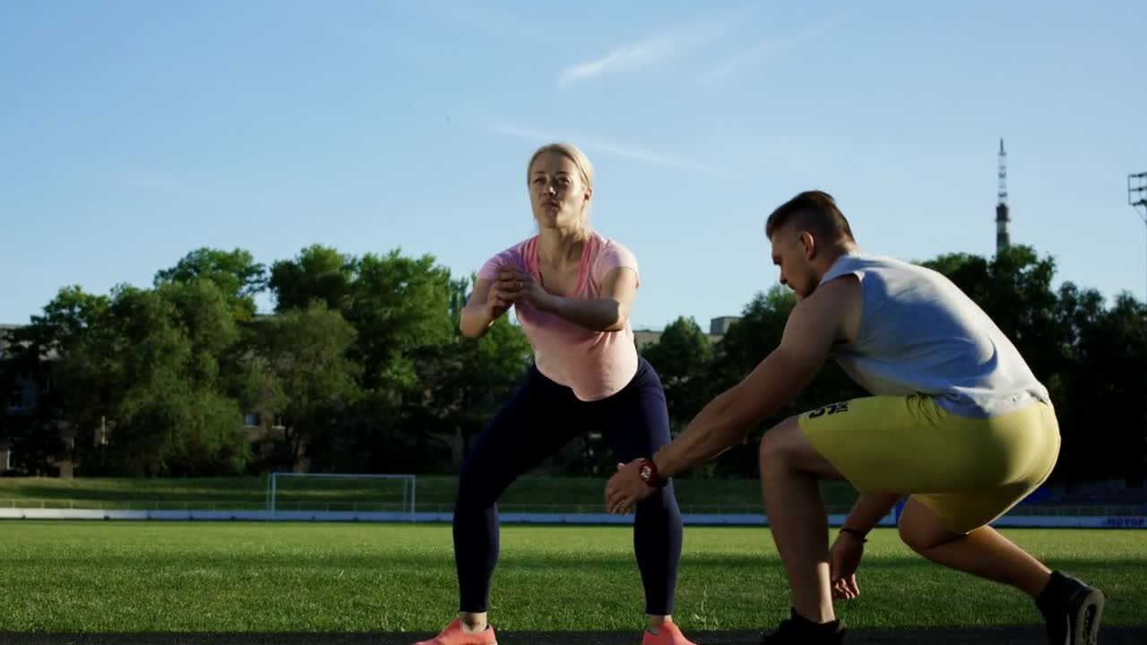 Stock Video A Trainer Helps A Woman With The Squats Training Live Wallpaper For PC
