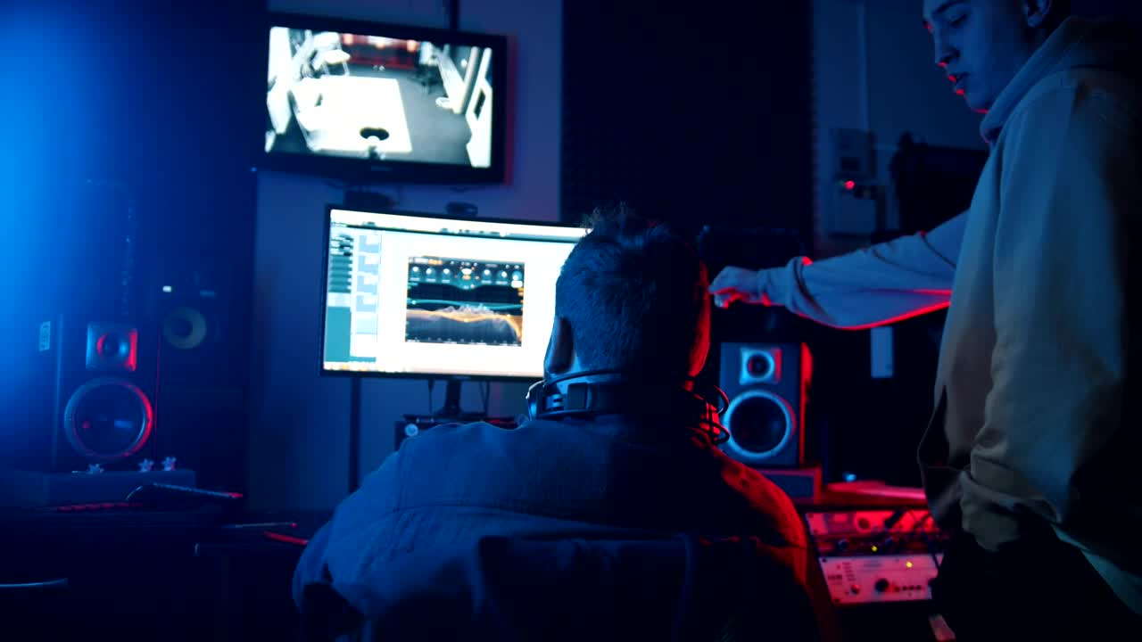 Stock Video A Sound Engineer And Singer Working On A Track In Live Wallpaper For PC