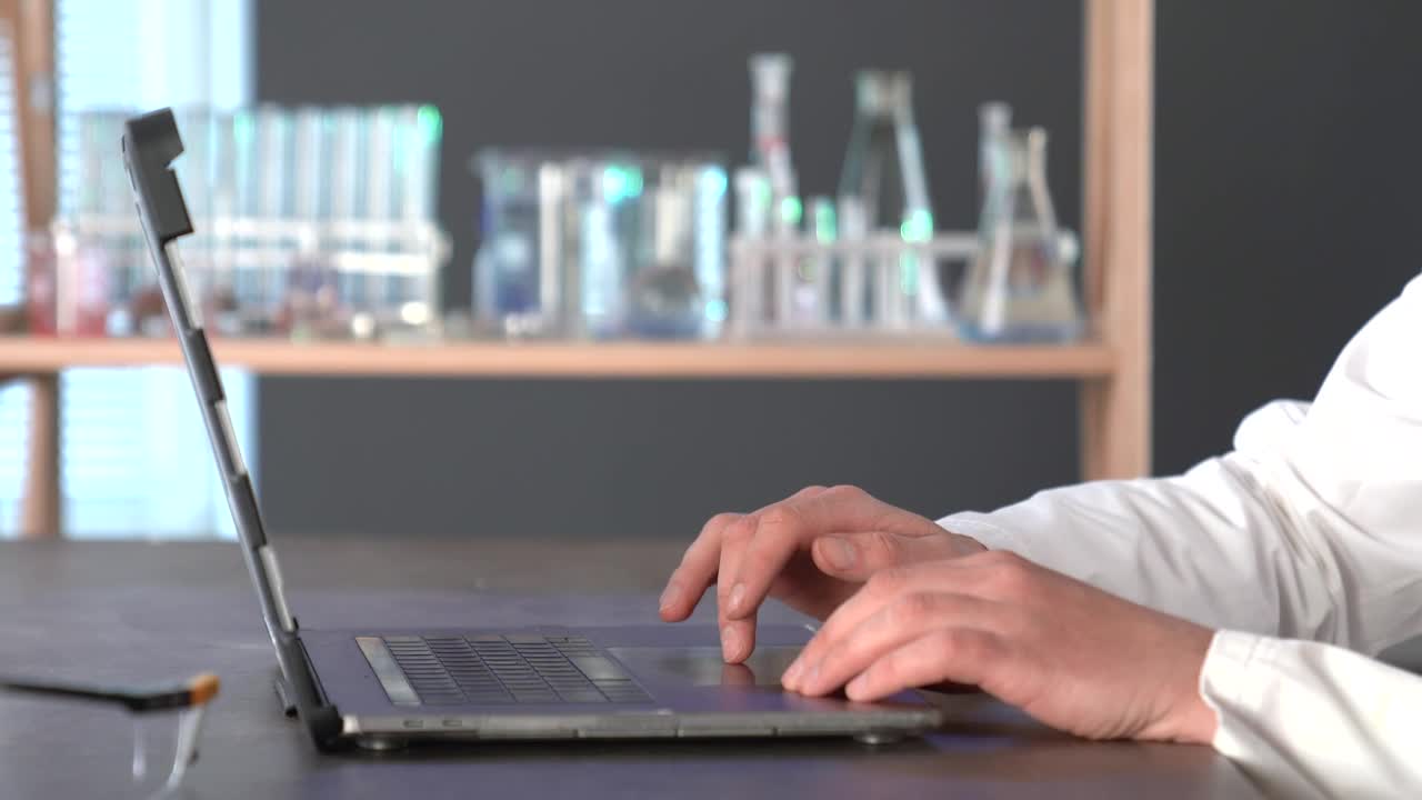 Stock Video A Scientist Typing On A Laptop In The Lab Live Wallpaper For PC