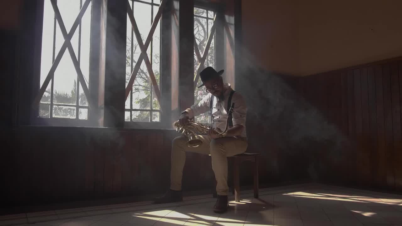 Stock Video A Saxophonist Sitting Holding A Saxophone Live Wallpaper For PC