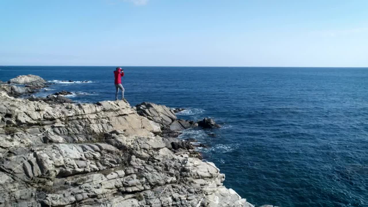 Stock Video A Person Taking Pictures Standing On A Cliff Live Wallpaper For PC