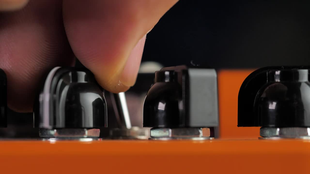 Stock Video A Person Adjusting The Levels Of Some Distortion Pedals Live Wallpaper For PC