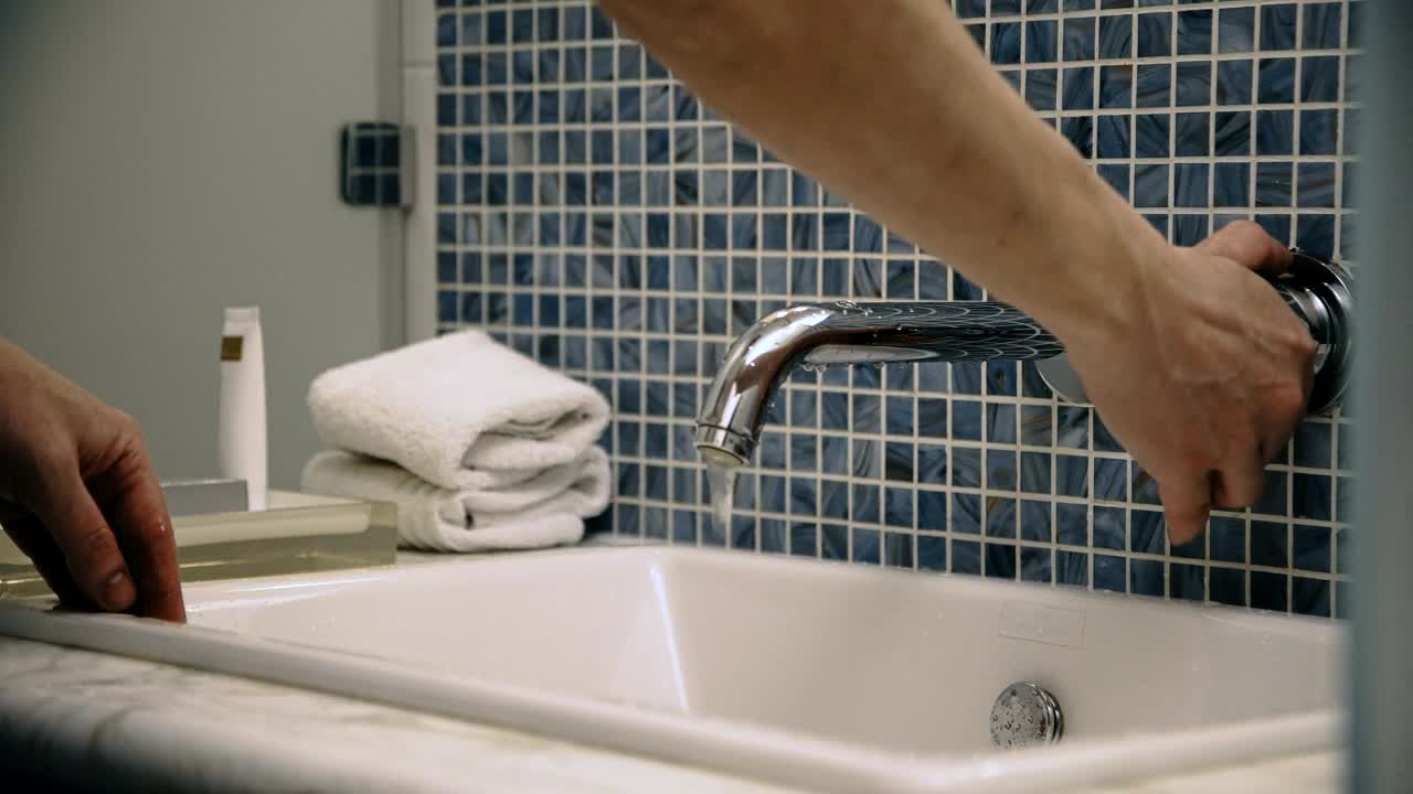 Stock Video A Man Washes His Face In The Bathroom Sink Live Wallpaper For PC